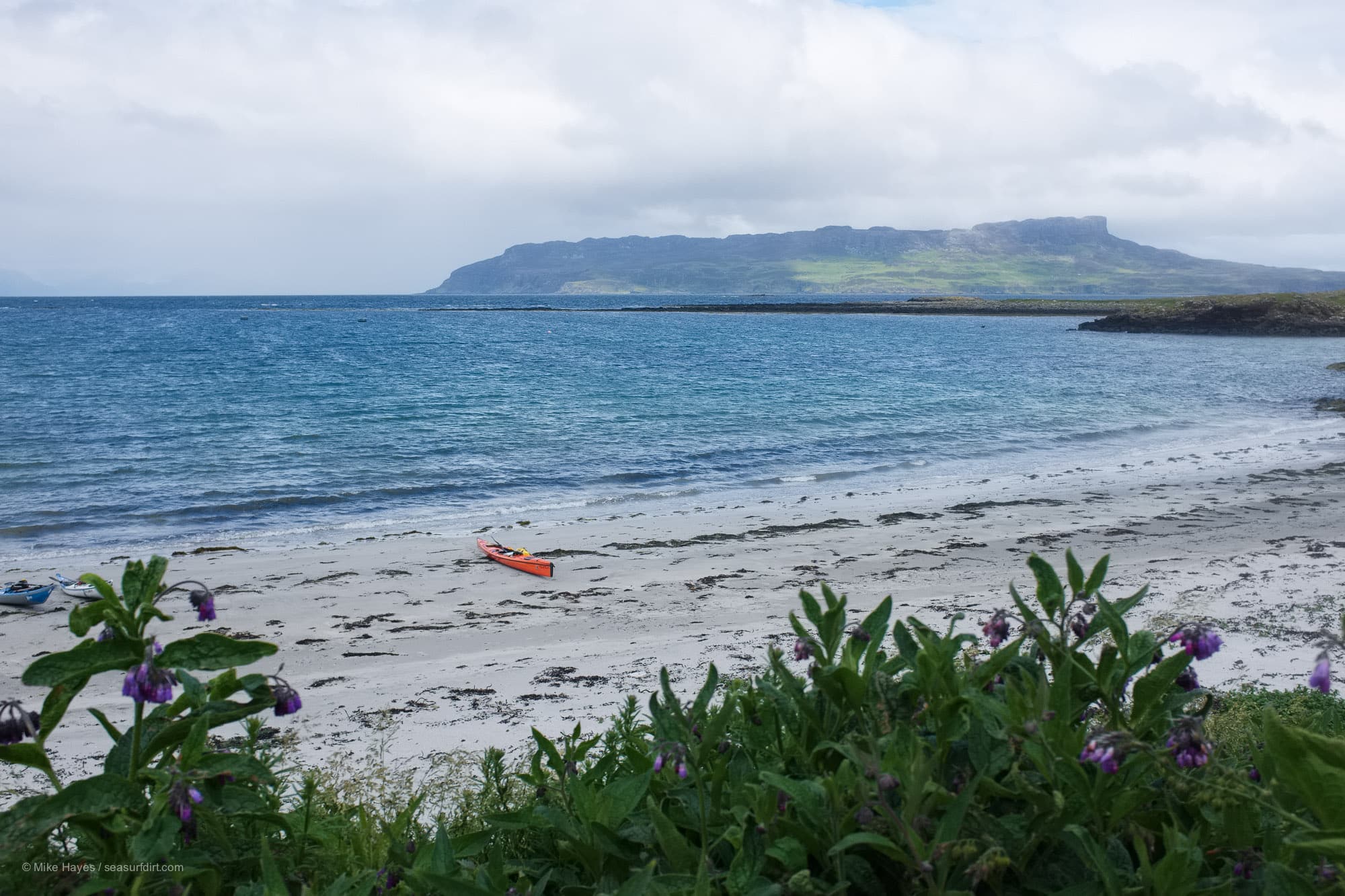 Sea kayaking around the Isle of Muck - Gallanach beach with the Isle of Eigg in the background.