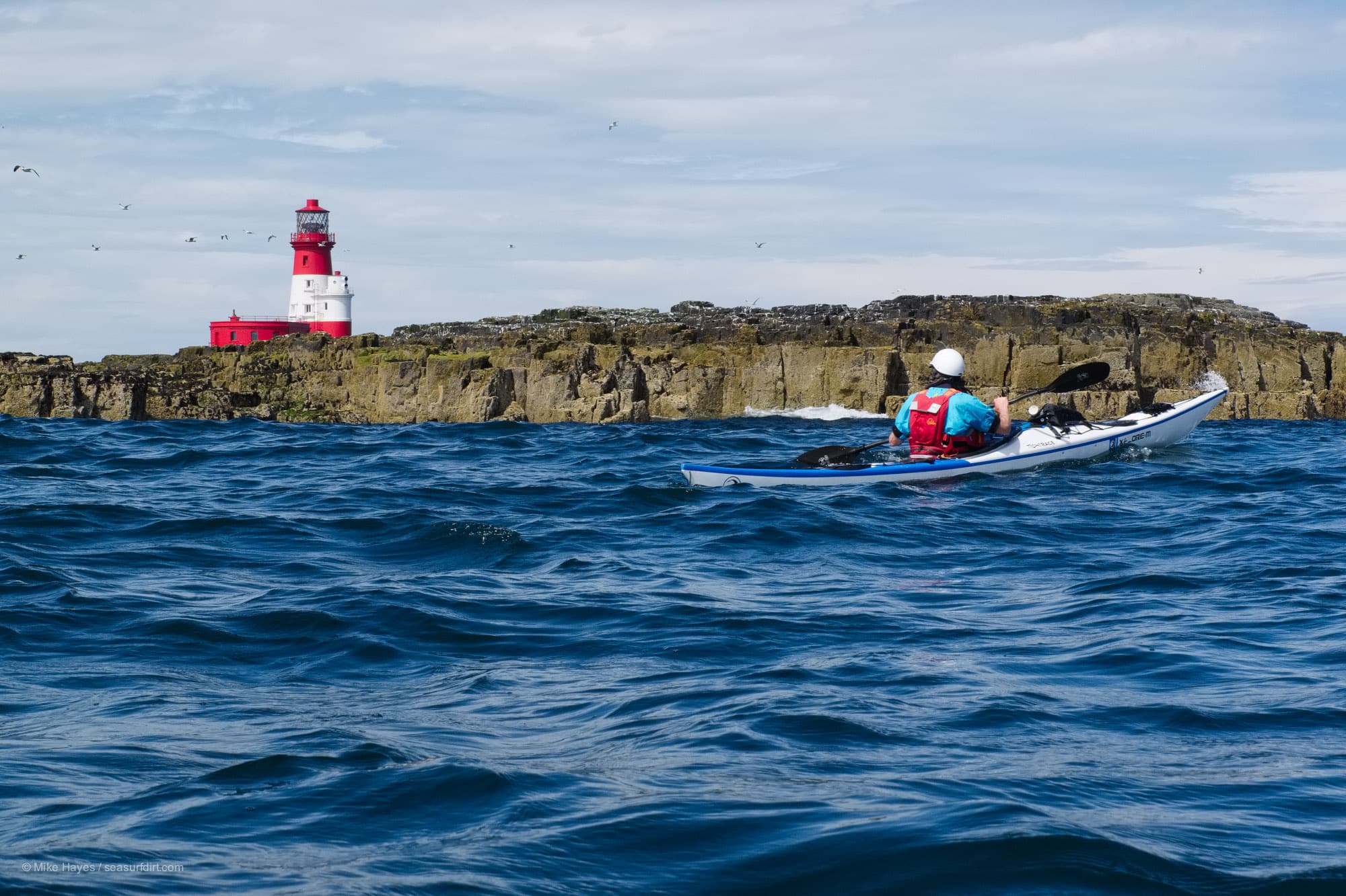 Sea kayaking past the Longstone Lighthouse in the Farne Islands